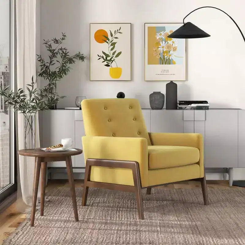 Fauteuil moderne en velours avec dossier capitonné et pieds en bois massif