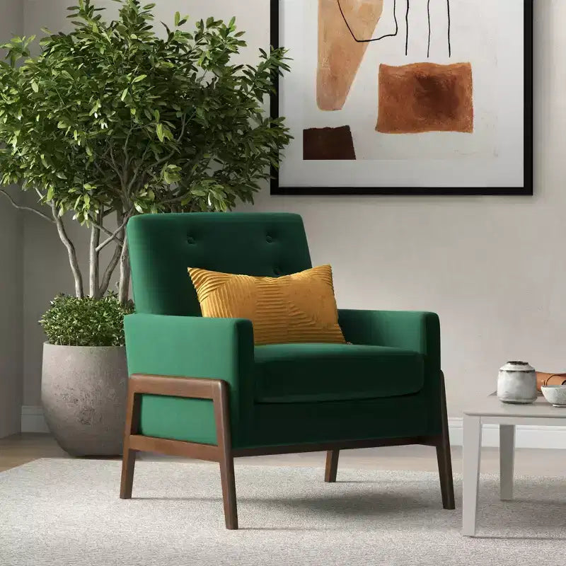 Fauteuil moderne en velours avec dossier capitonné et pieds en bois massif