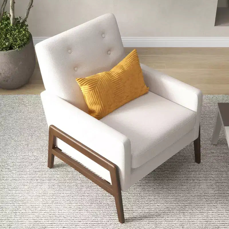 Fauteuil moderne en velours avec dossier capitonné et pieds en bois massif