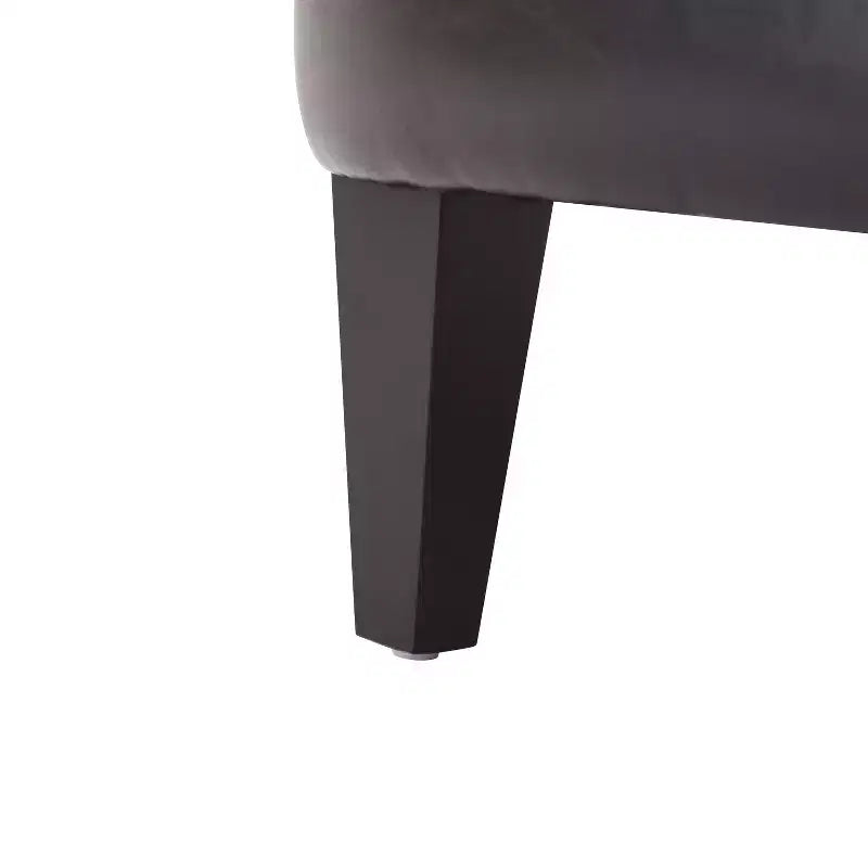 Un fauteuil inclinable capitonné de style vintage orné de rivets et de pieds en bois