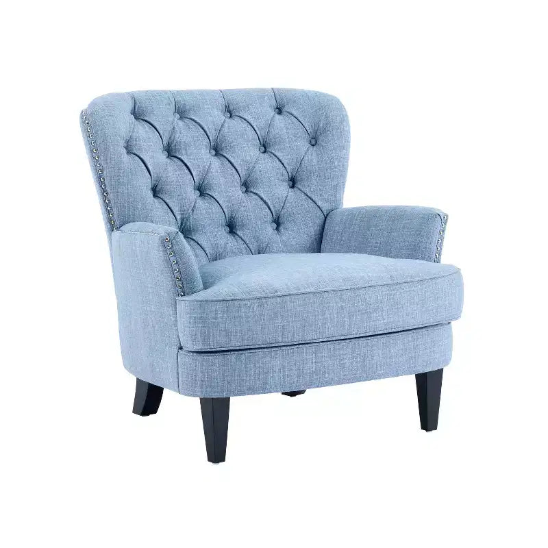 Un fauteuil inclinable capitonné de style vintage orné de rivets et de pieds en bois