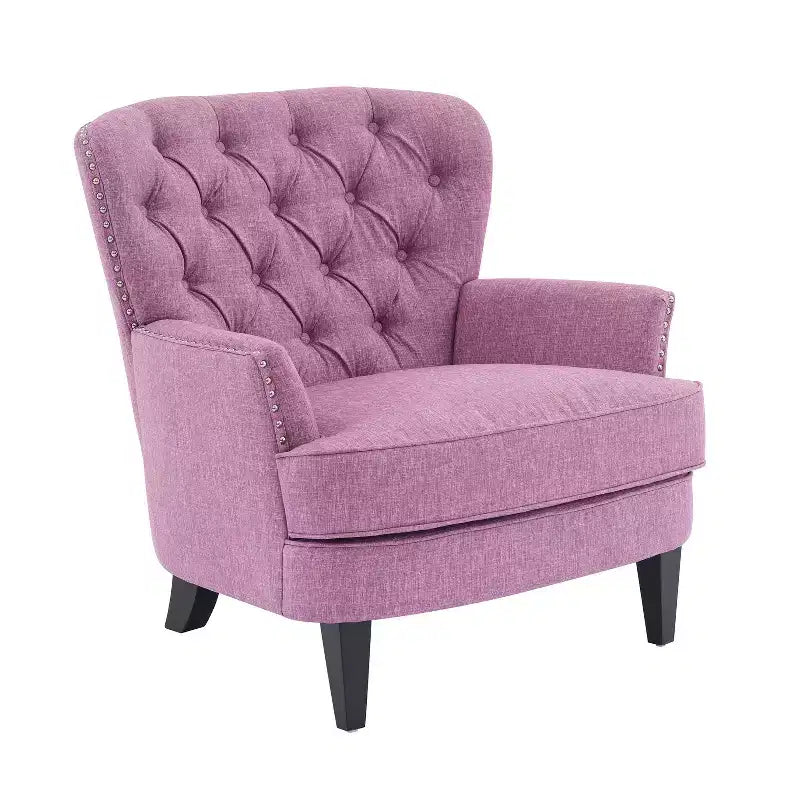Un fauteuil inclinable capitonné de style vintage orné de rivets et de pieds en bois