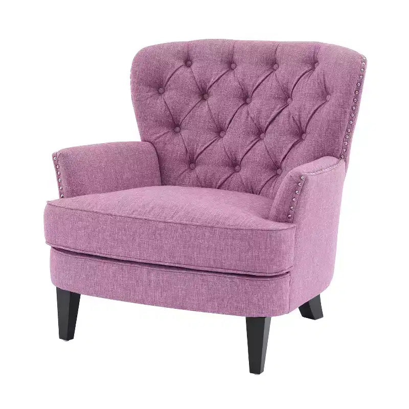 Un fauteuil inclinable capitonné de style vintage orné de rivets et de pieds en bois